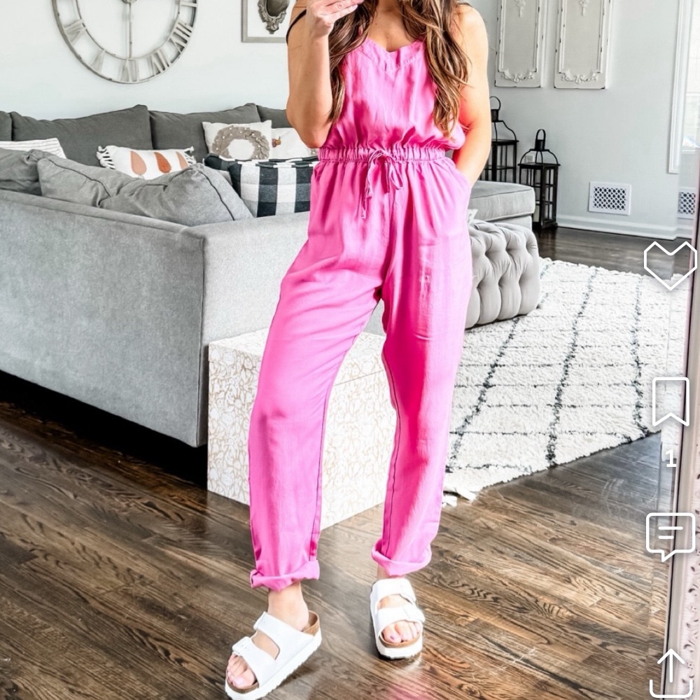 Soft flowy pink lightweight sleeveless jumpsuit cinched tie waist with pockets.